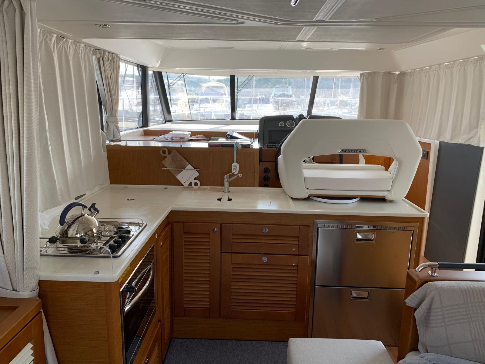 Galley with full kitchen, stove, and refrigerator