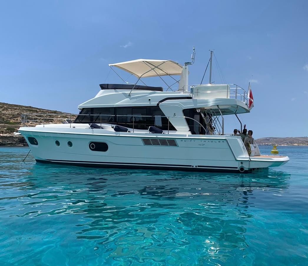 Bandama Yacht — Beneteau Swift Trawler 47 anchored at Comino, Malta