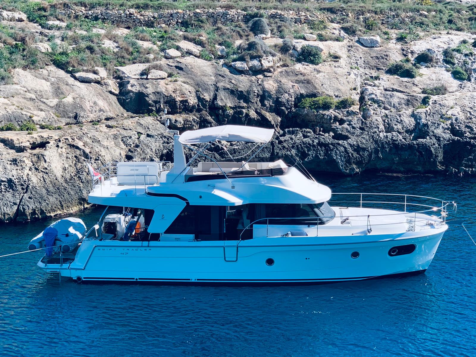 Bandama yacht anchored near a rocky cove in Malta