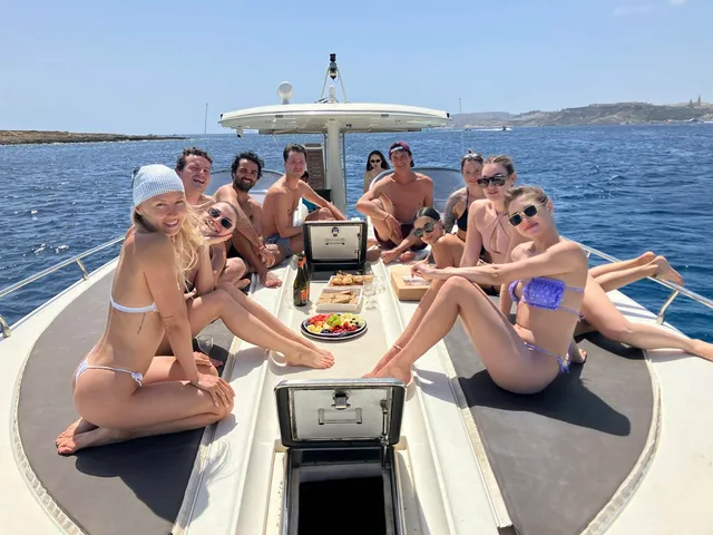 Guests on the bow with a platter and champagne